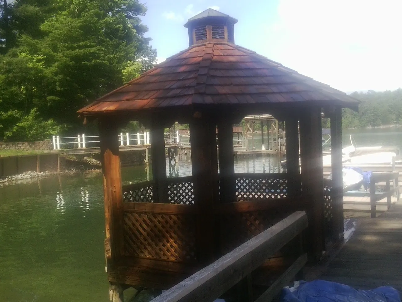 Cedar shake gazebo roof rebuilt on a lake dock in Shelby